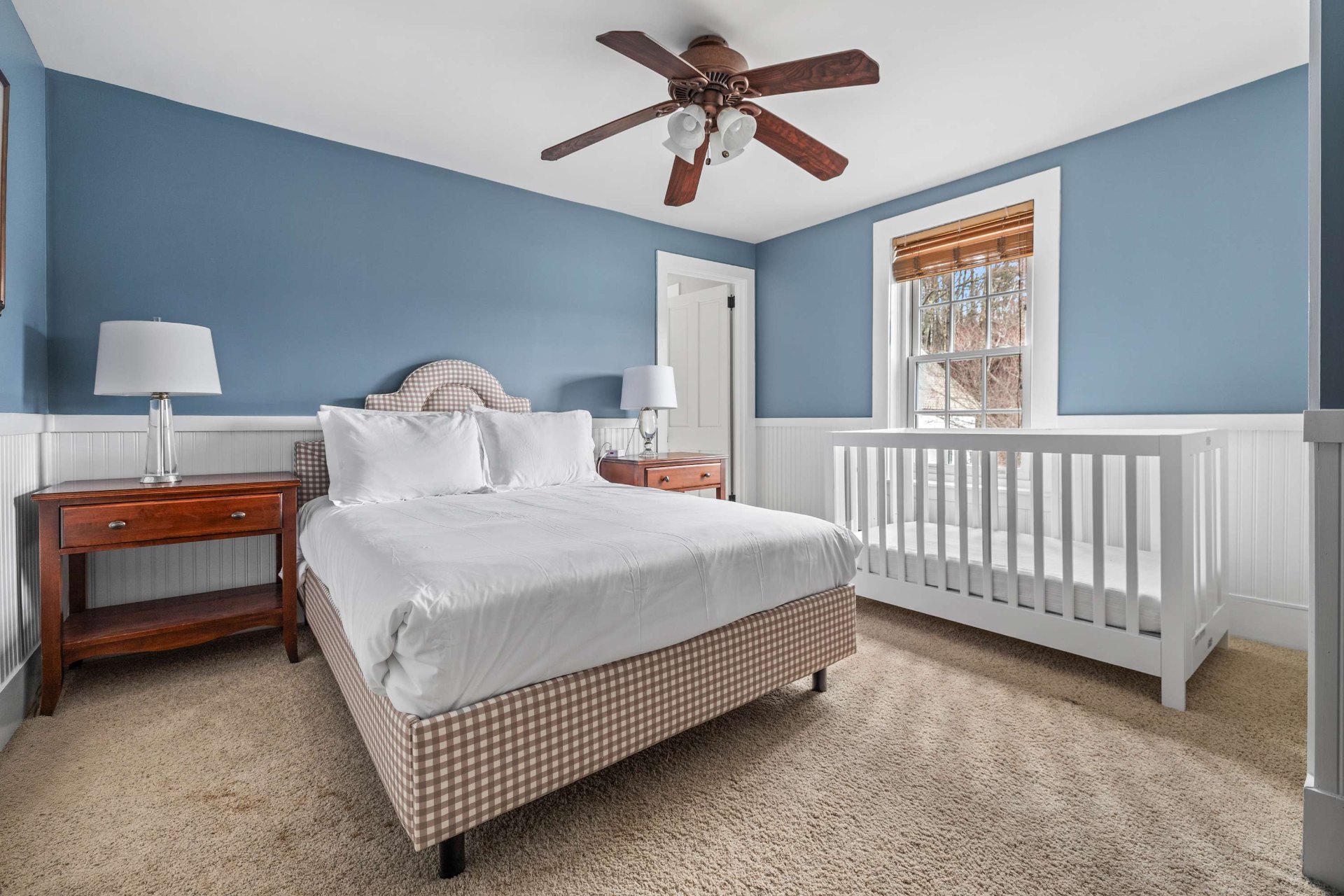 Upstairs bedroom with queen bed and crib, ideal for families with little ones